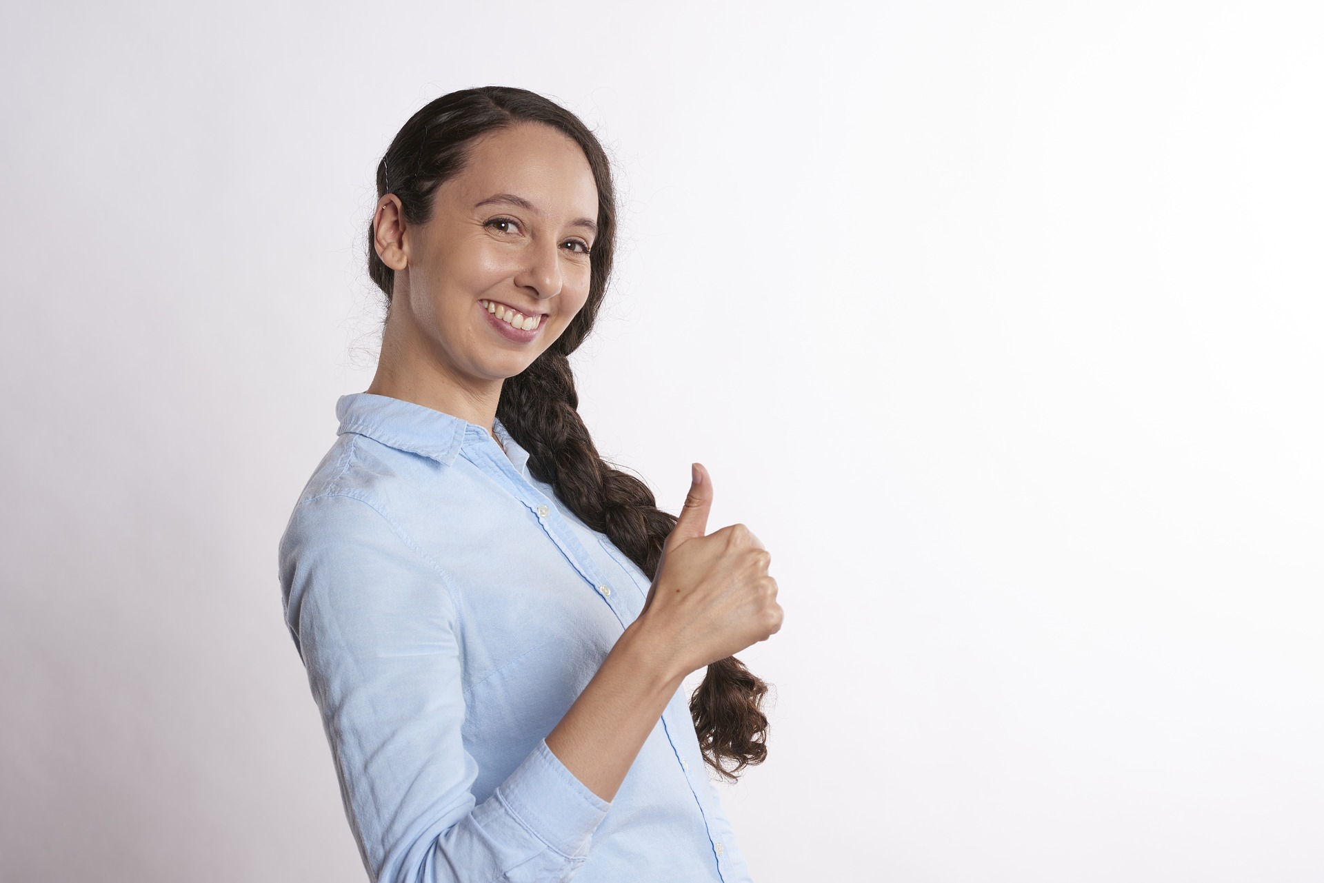 woman in blue shirt with thumbs up