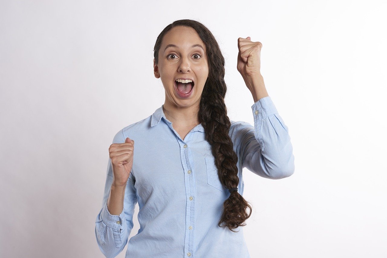 woman in blue shirt with thumbs up